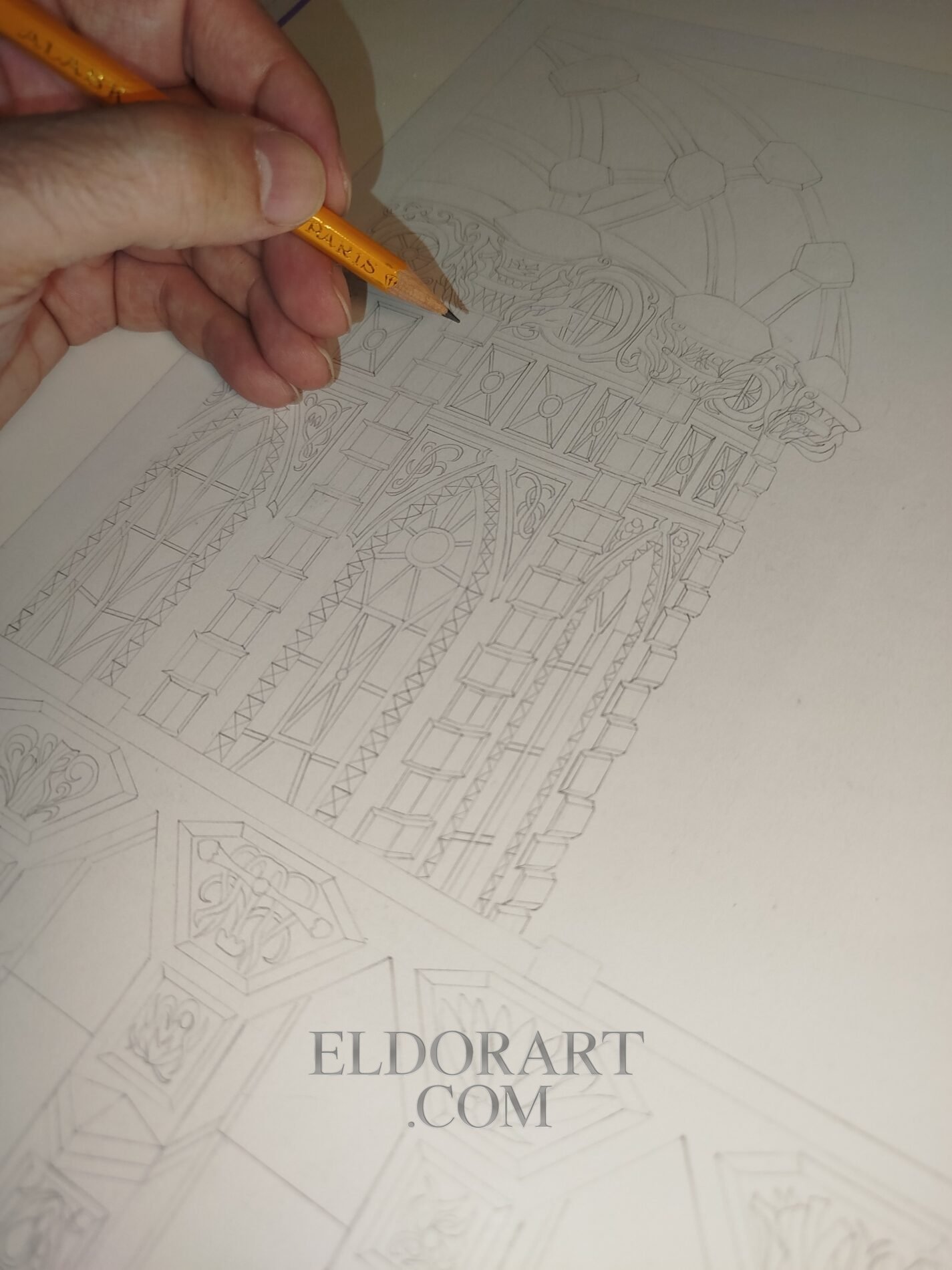 The Al-Arim Dam and Its Watchtower – Eldor Art 7 Close-up of an artist holding a pencil and tracing initial line art outlines for The Al-Harim Dam and Its Watchtower on Bristol paper, illustrating the early creation process by Eldor Art.