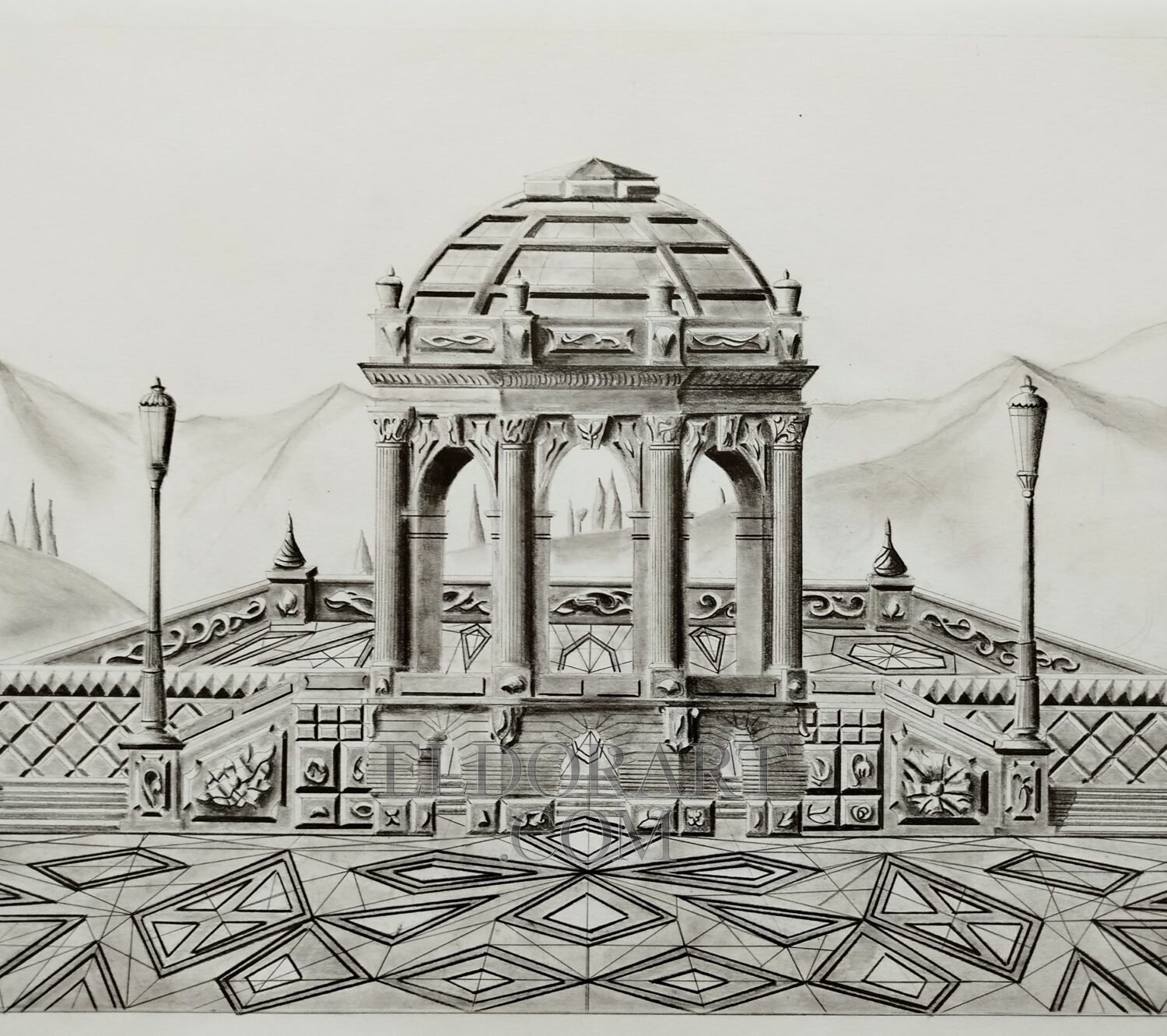 A highly detailed, complete hand-drawn graphite pencil perspective of The Belvedere of Syrabis by Eldor Art, executed on 180g Bristol paper. This symmetrical view presents the ornate multi-arched belvedere building with its decorative dome, set upon a raised terrace. The composition includes steps, four classical lamp posts, and complex geometric floor tiling, overlooking a distant, softly shaded mountain landscape. The artist’s signature is visible in the lower right.